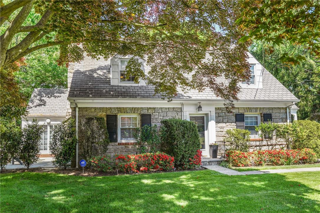 a front view of house with yard and green space