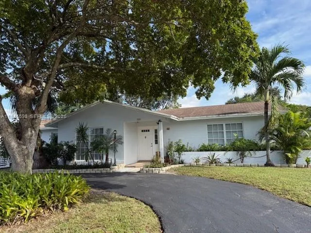 a front view of a house with garden and porch