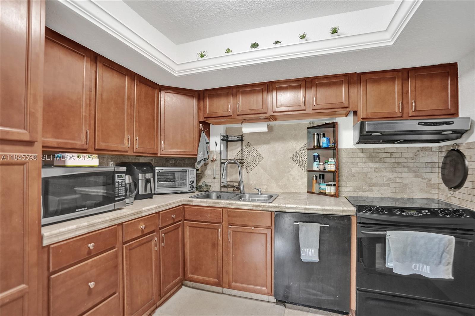 520 Southwest 62nd Avenue Margate, FL 33068 - Photo 19 of 34 a kitchen with stainless steel appliances granite countertop a stove a sink and a microwave