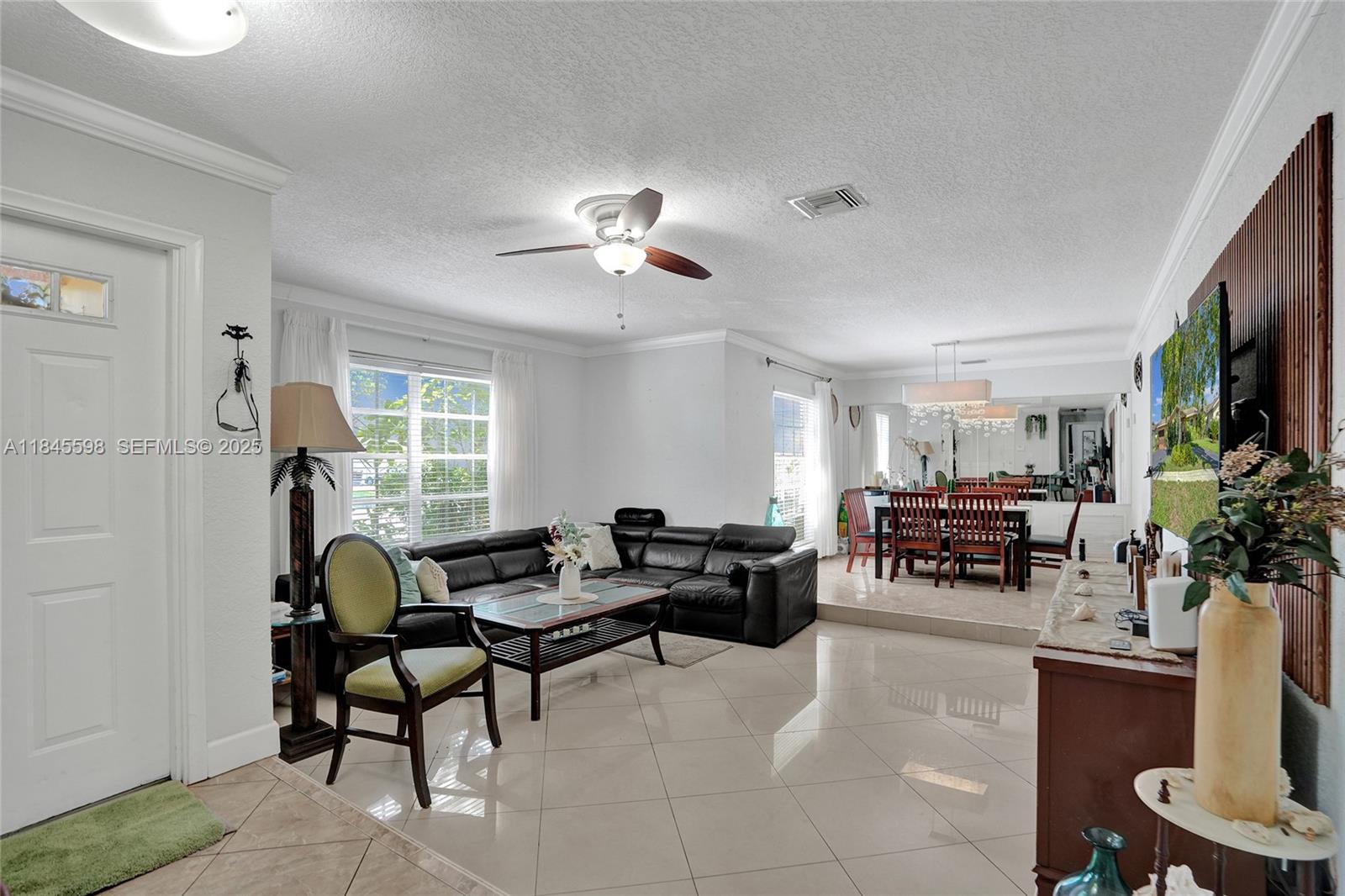 520 Southwest 62nd Avenue Margate, FL 33068 - Photo 22 of 34 a living room with furniture potted plant and a window