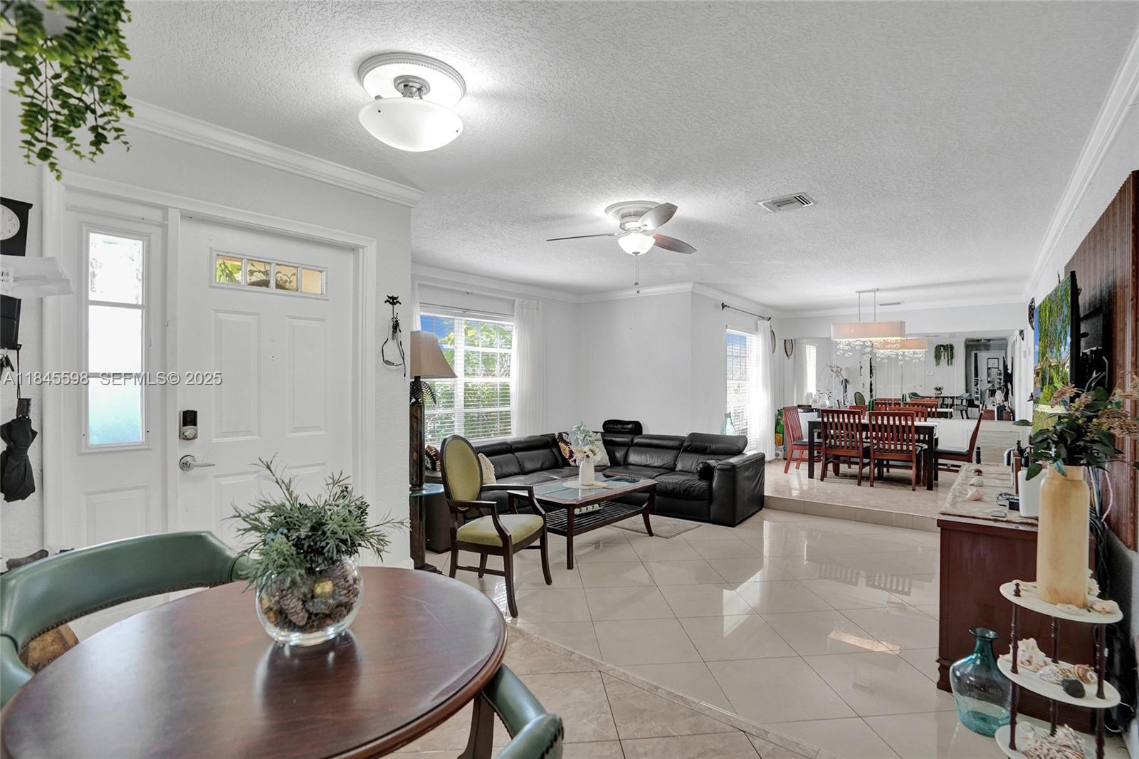 520 Southwest 62nd Avenue Margate, FL 33068 - Photo 23 of 34 a living room with furniture flowers and a chandelier