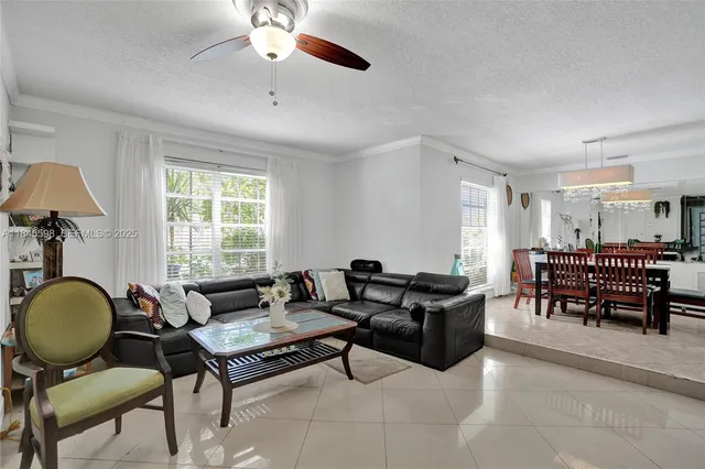 a living room with furniture a window and a chandelier