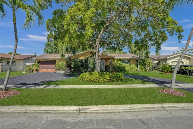 a front view of a house with a yard and a garage