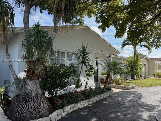520 Southwest 62nd Avenue Margate, FL 33068 - Photo 3 of 34 a couple of palm trees in front of house