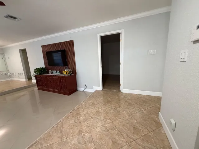 a bedroom with furniture and flat screen tv