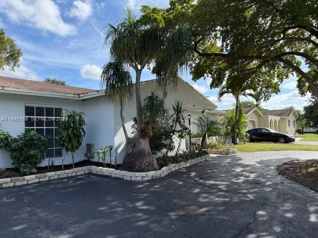 a view of a house with a yard and tree s
