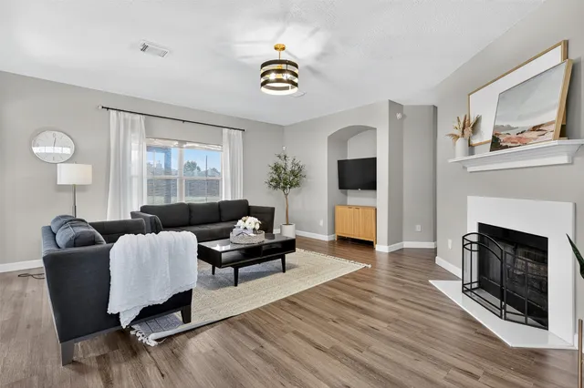 a view of a hallway with wooden floor and entryway