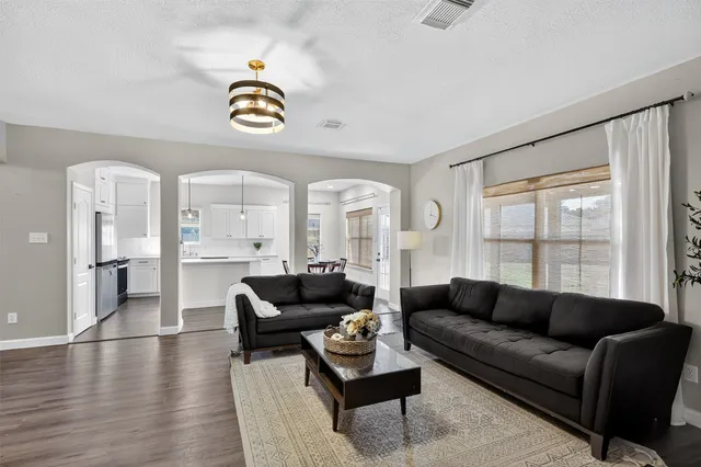 a living room with furniture and a potted plant