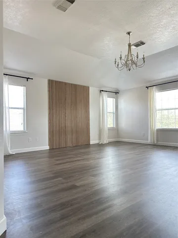 a view of a workspace with wooden floor
