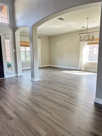 a view of a dining room with furniture wooden floor and chandelier