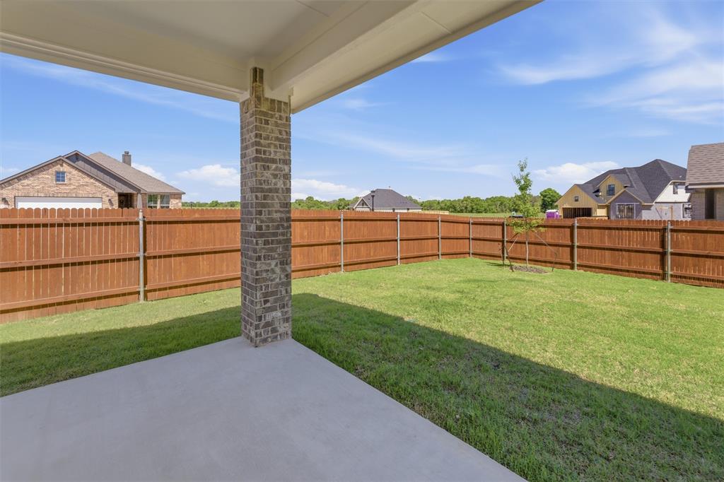 1221 Sabine River Lane Springtown, TX 76082 - Photo 21 of 25 Fenced backyard featuring a patio and a residential view