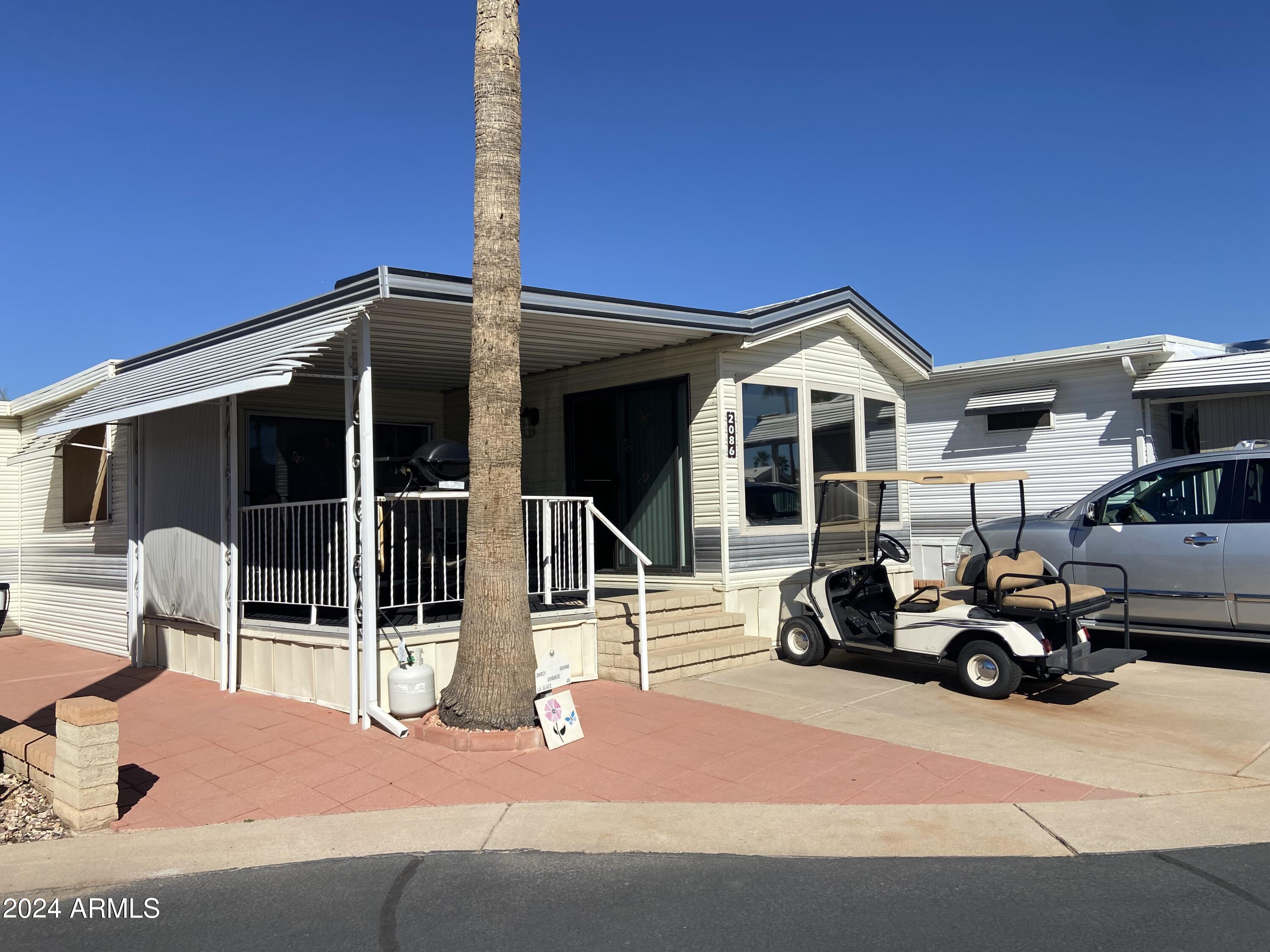 2086 West Klamath Avenue, Unit 86 Apache Junction, AZ 85119 - Photo 1 of 17 a car parked in front of a house