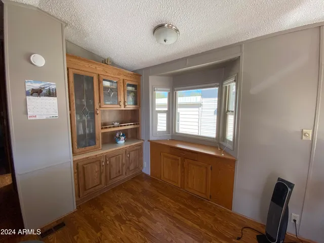 a kitchen with granite countertop a refrigerator and wooden cabinets
