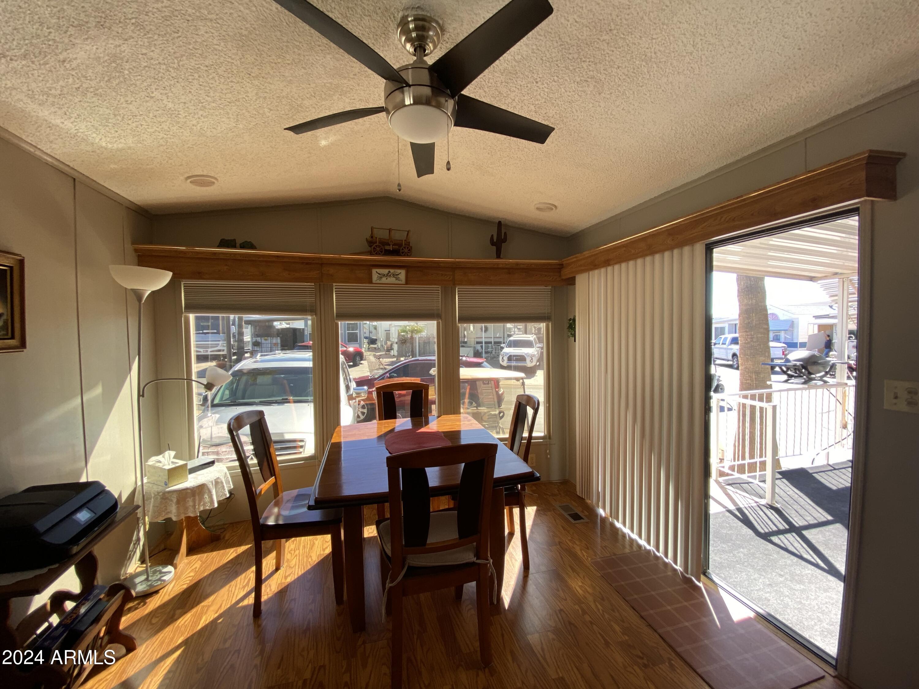 2086 West Klamath Avenue, Unit 86 Apache Junction, AZ 85119 - Photo 12 of 17 a view of a dining room with furniture window and outside view