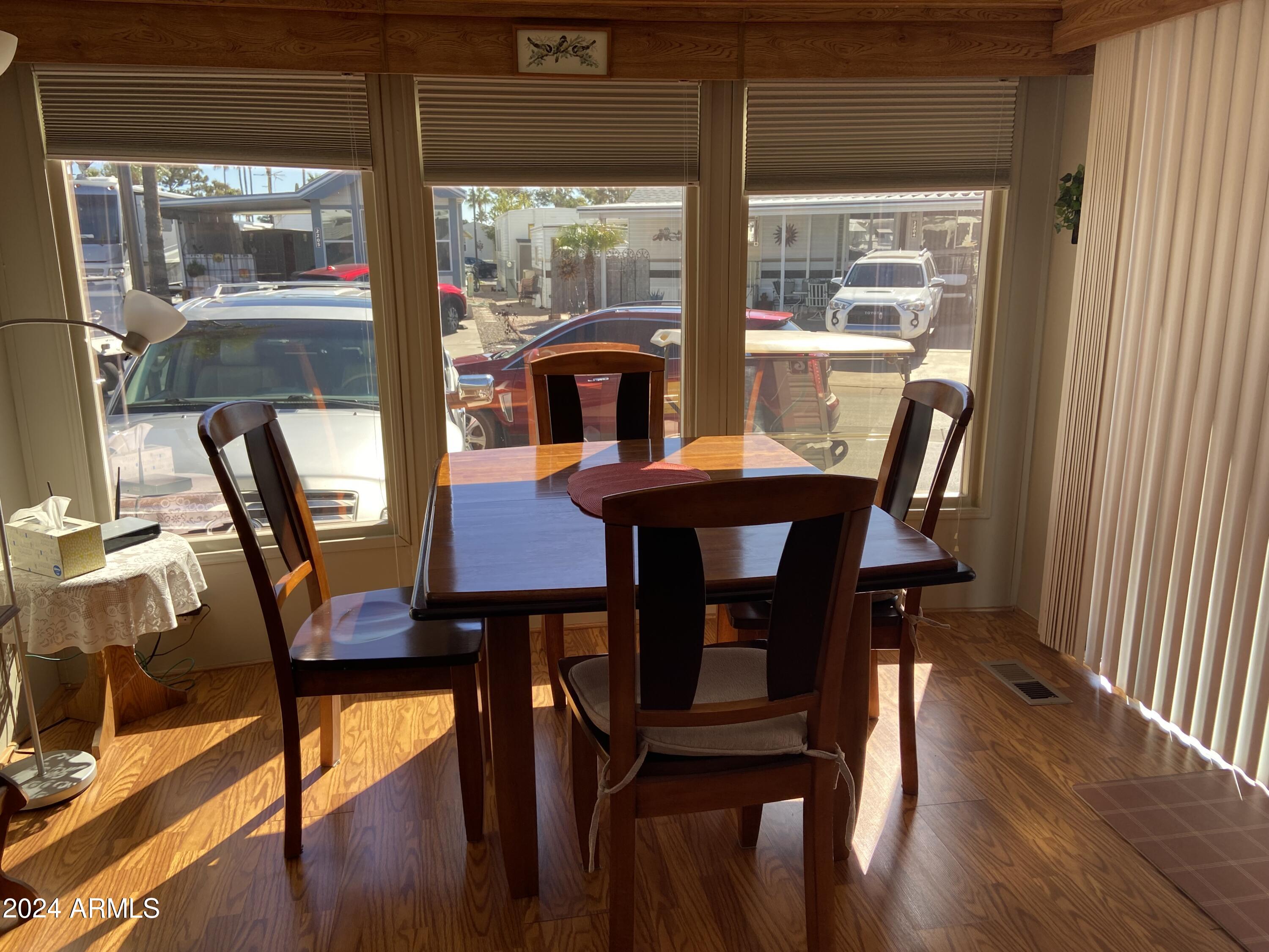 2086 West Klamath Avenue, Unit 86 Apache Junction, AZ 85119 - Photo 13 of 17 a view of a dining room with furniture and wooden floor