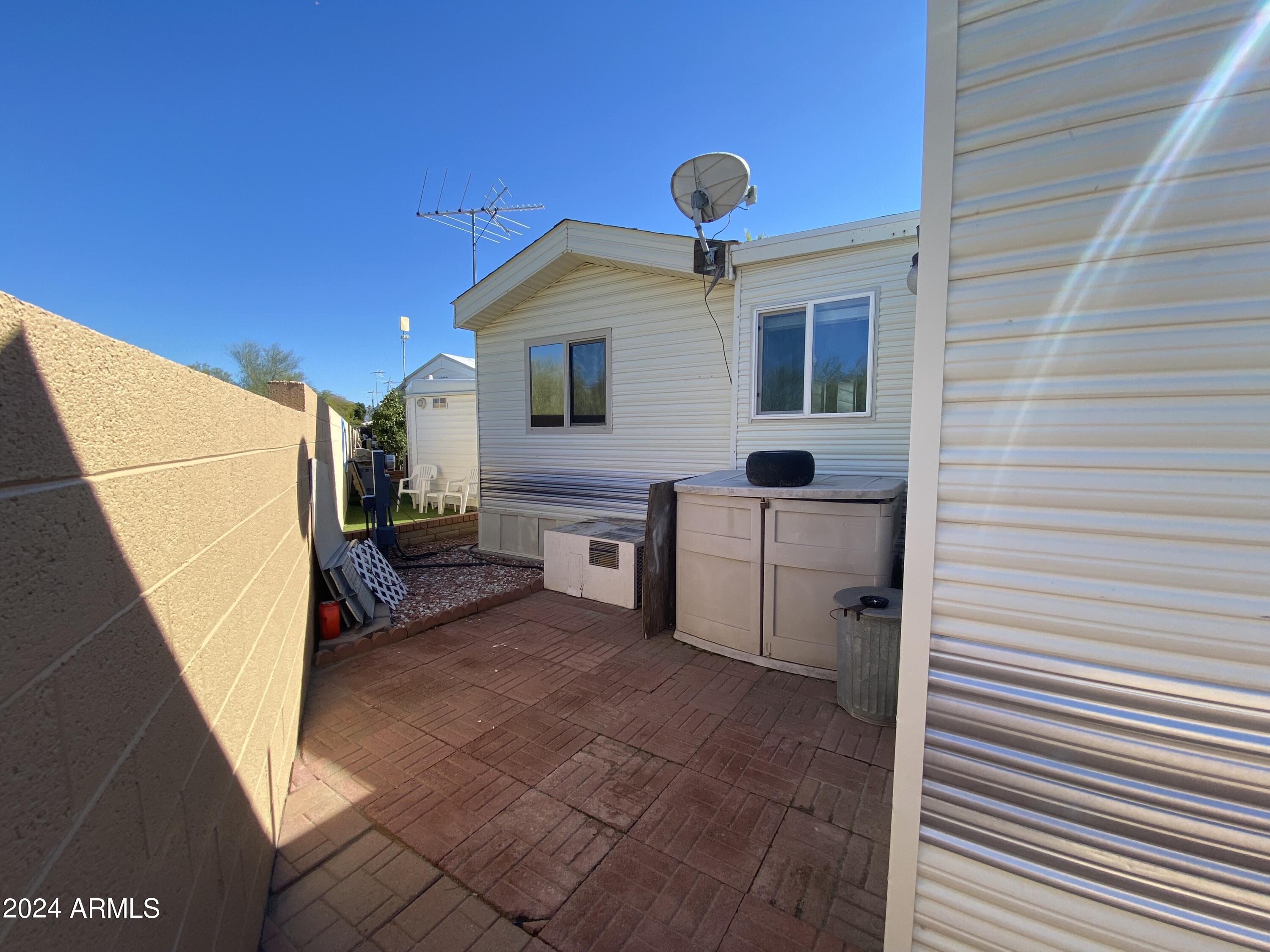 2086 West Klamath Avenue, Unit 86 Apache Junction, AZ 85119 - Photo 16 of 17 a view of a house with backyard and furniture