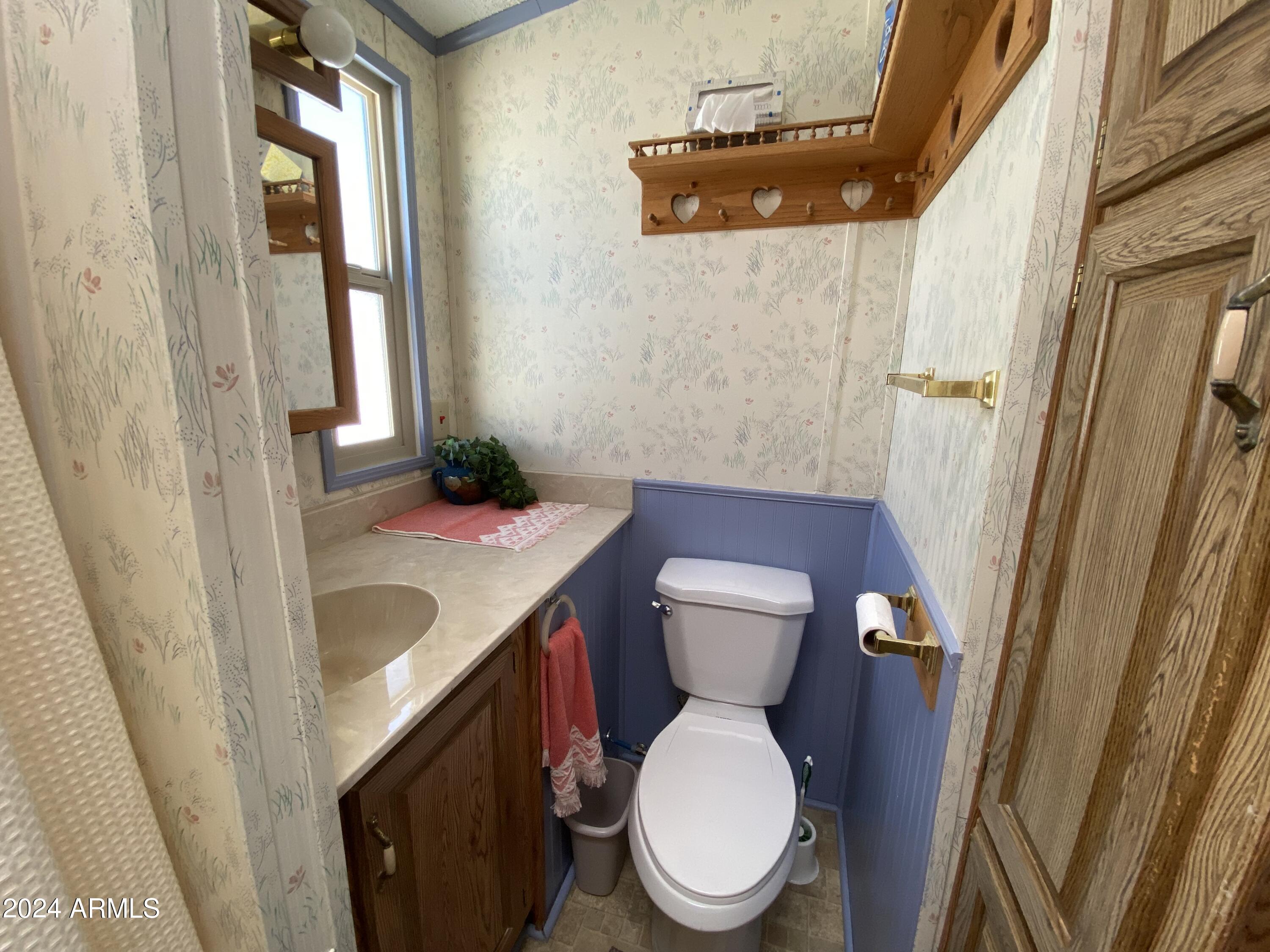 2086 West Klamath Avenue, Unit 86 Apache Junction, AZ 85119 - Photo 8 of 17 a bathroom with a sink and a mirror