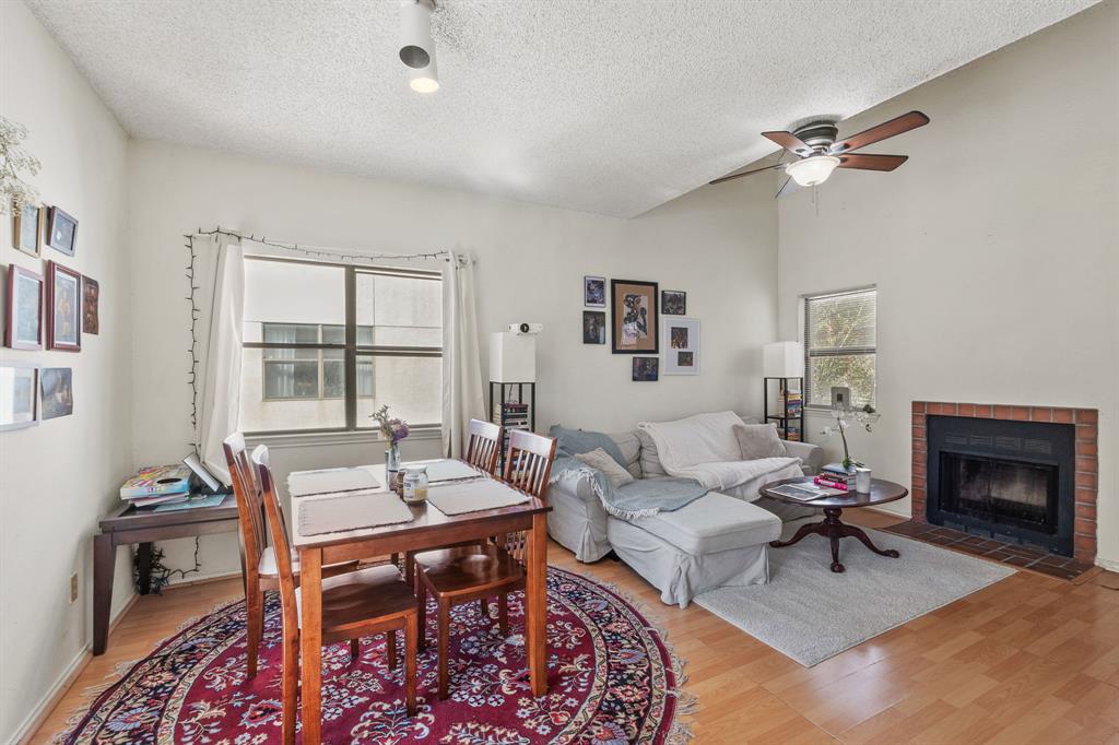 706 West 22nd Street, Unit 201 Austin, TX 78705 - Photo 3 of 11 a living room with furniture a rug and a fireplace