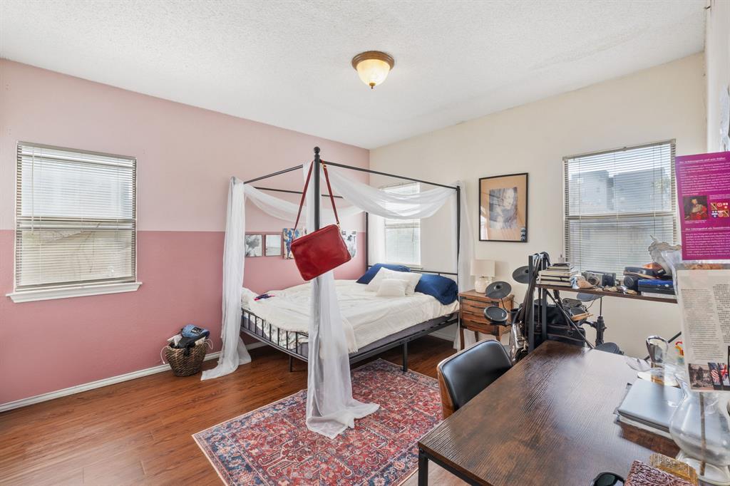 706 West 22nd Street, Unit 201 Austin, TX 78705 - Photo 6 of 11 a bed room with furniture and wooden floor