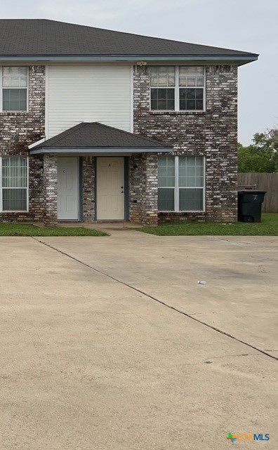 4005 Doraine Court, Unit C Killeen, TX 76549 - Photo 1 of 10 a front view of a house with a garage and a yard