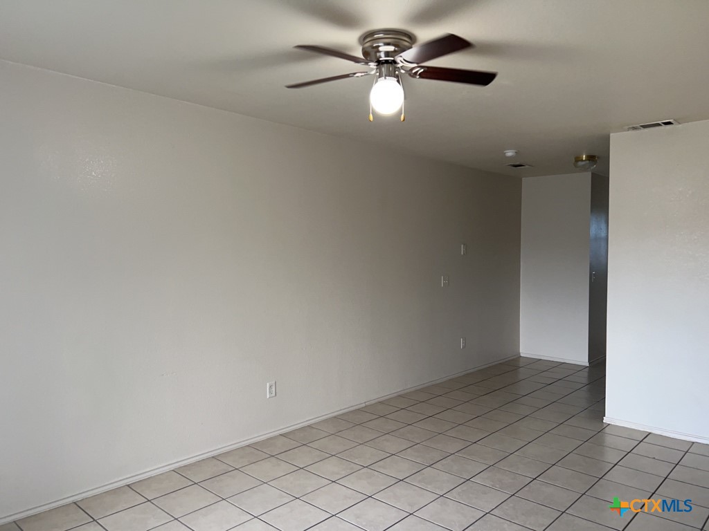 4005 Doraine Court, Unit C Killeen, TX 76549 - Photo 3 of 10 an empty room with a ceiling fan and carpet