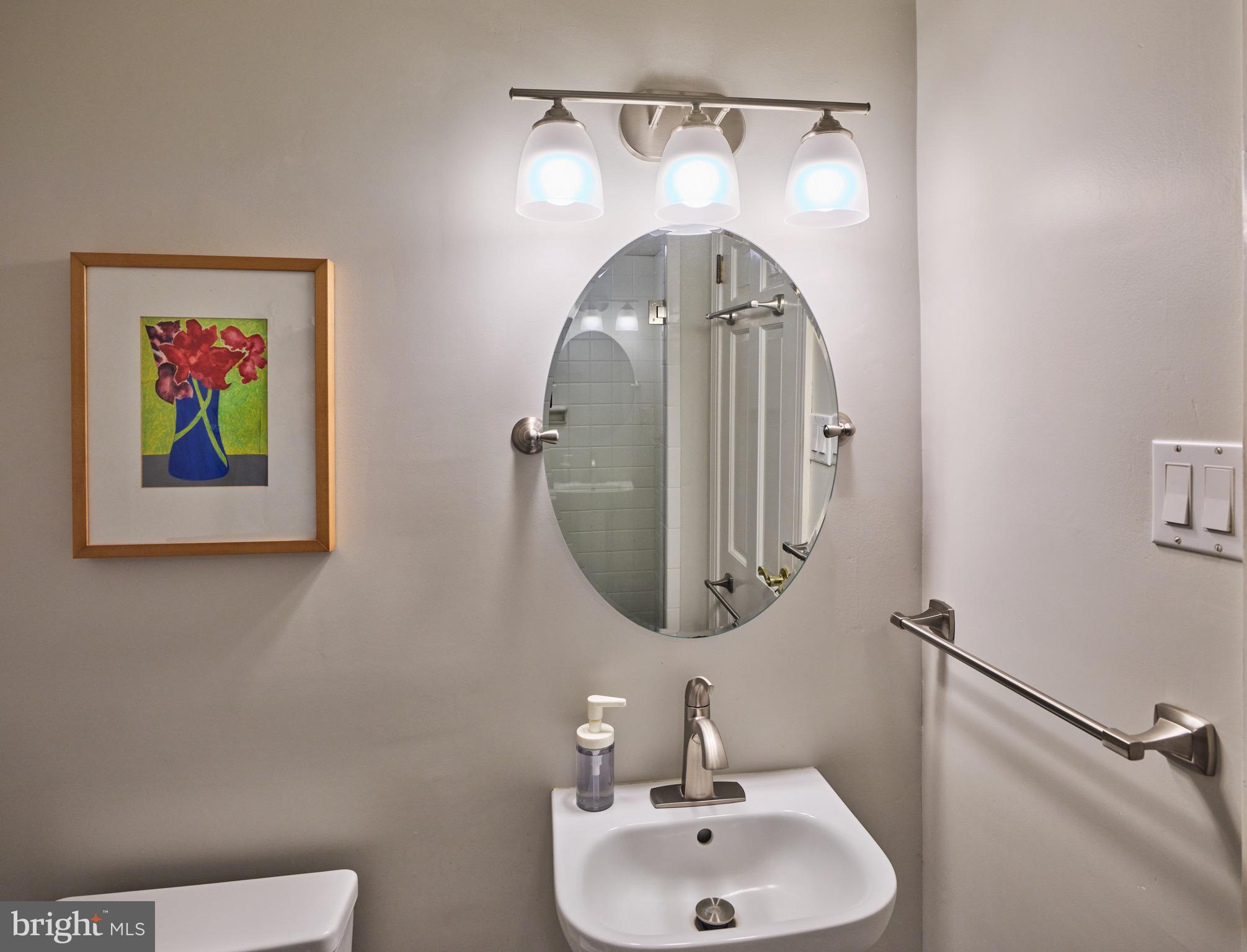 4990 Point Pleasant Pike Doylestown, PA 18902 - Photo 14 of 38 a bathroom with a toilet sink and mirror