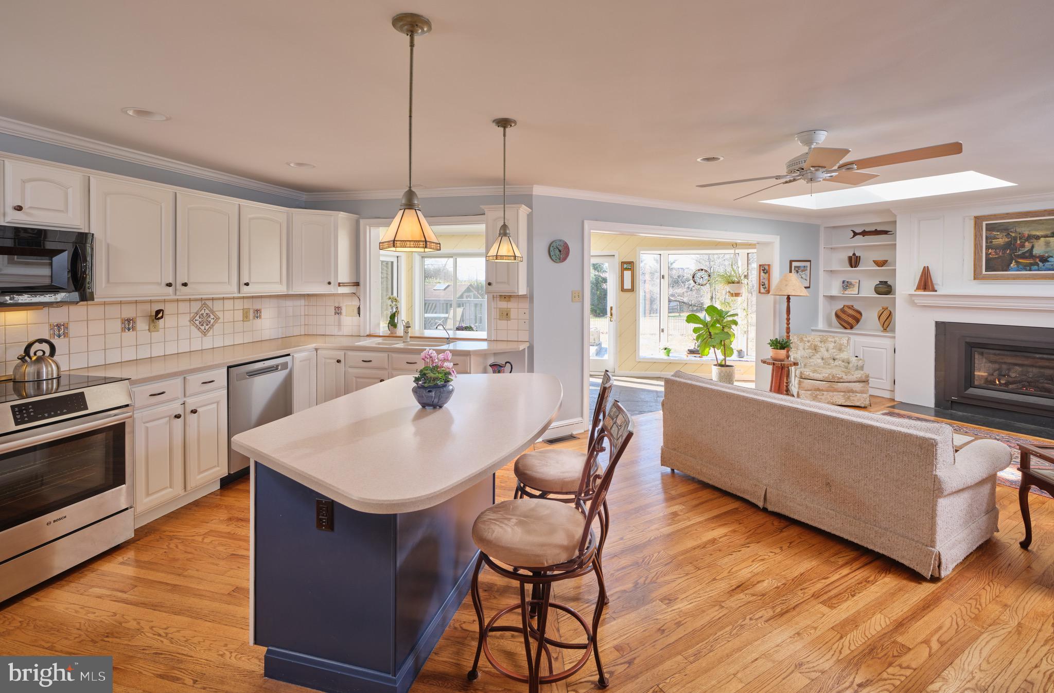 4990 Point Pleasant Pike Doylestown, PA 18902 - Photo 3 of 38 a kitchen with stainless steel appliances granite countertop a kitchen island hardwood floor sink stove dining table and chairs