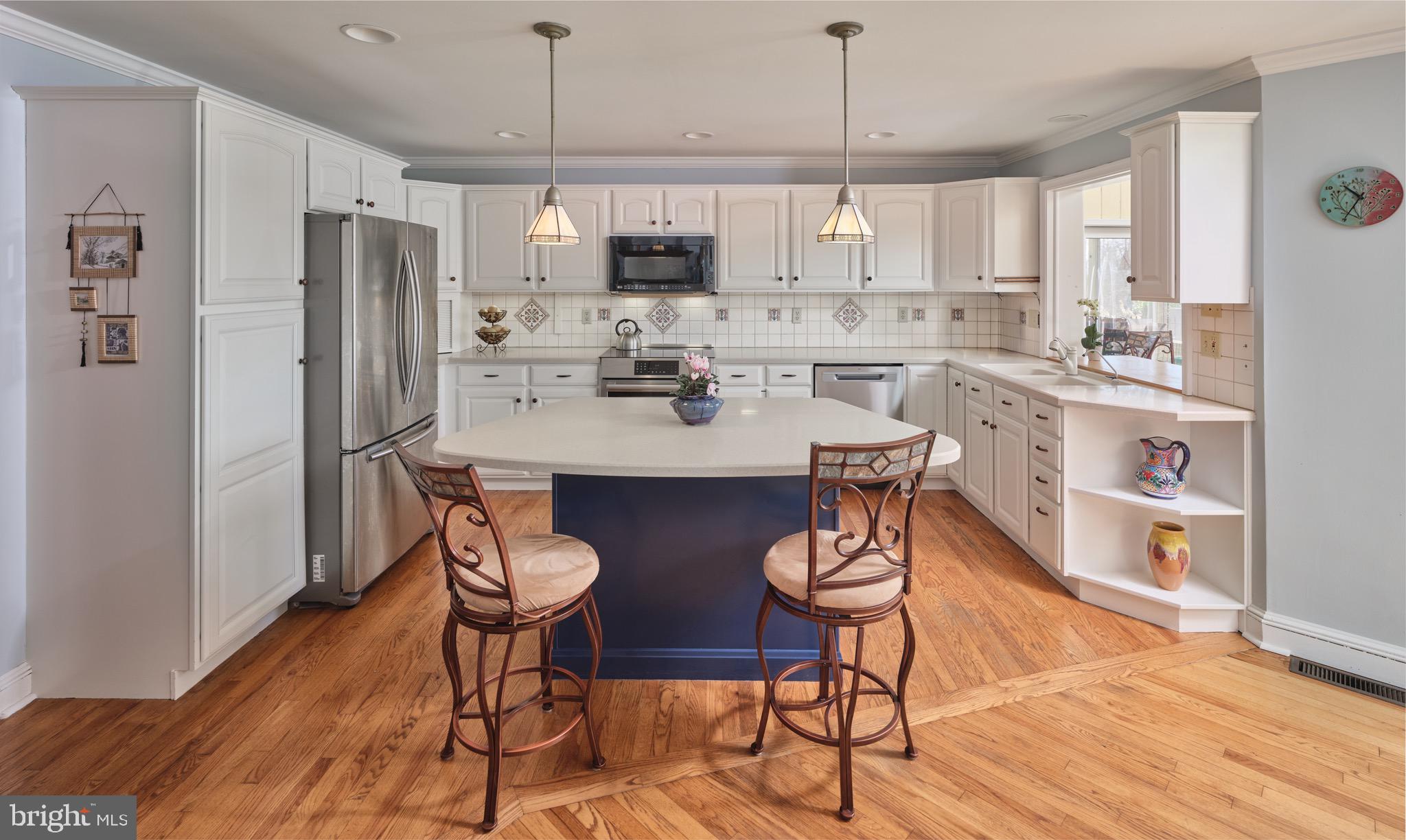 4990 Point Pleasant Pike Doylestown, PA 18902 - Photo 5 of 38 a kitchen with stainless steel appliances a dining table chairs refrigerator and sink