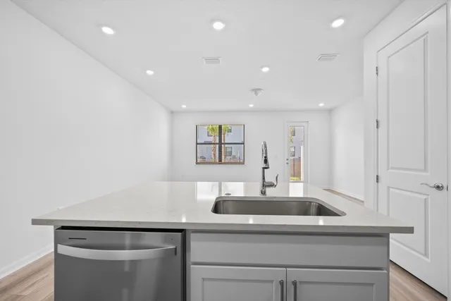 a kitchen with a sink and a refrigerator