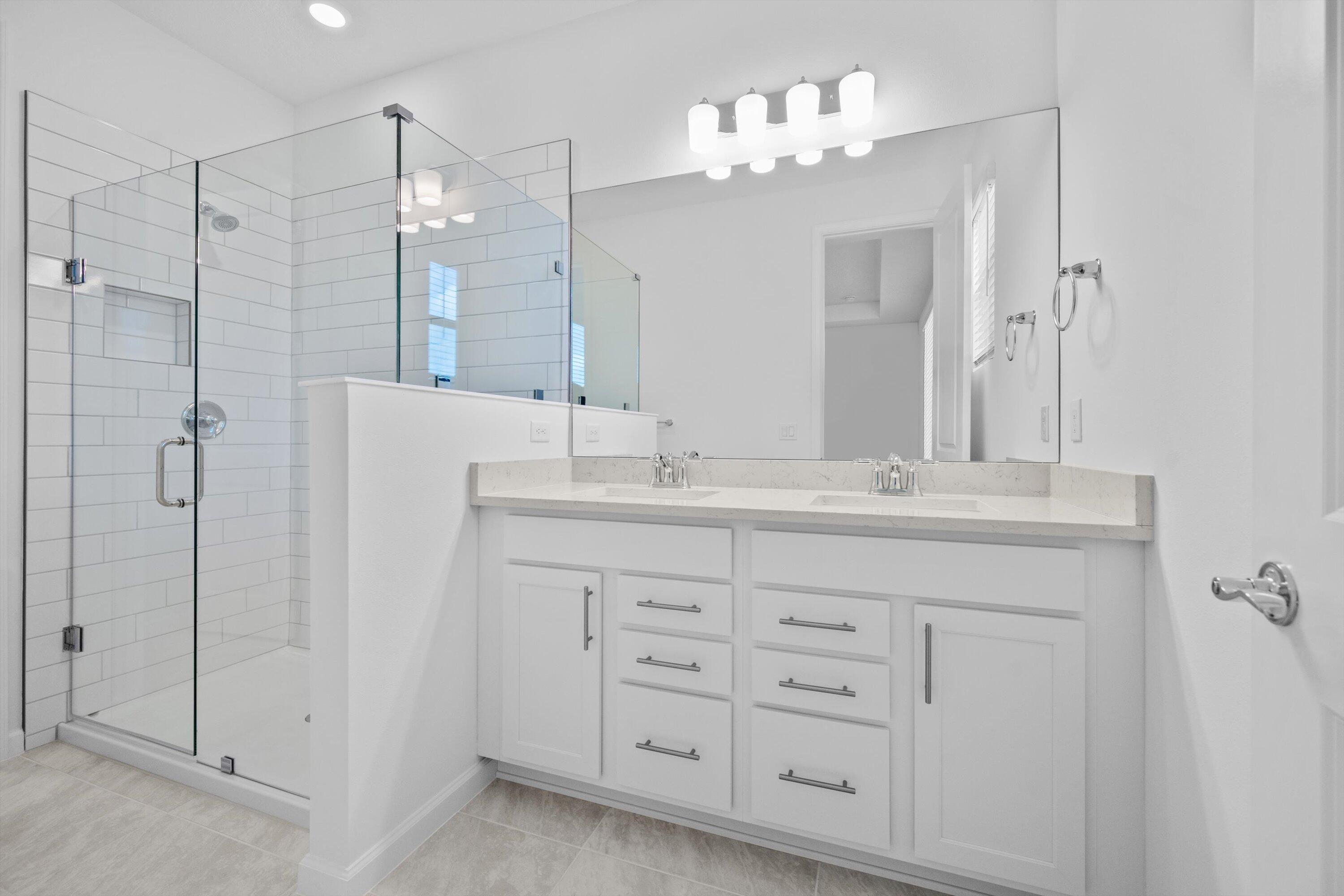 7638 Southwest Lucy Lane Stuart, FL 34997 - Photo 19 of 45 a bathroom with a double vanity sink mirror and shower