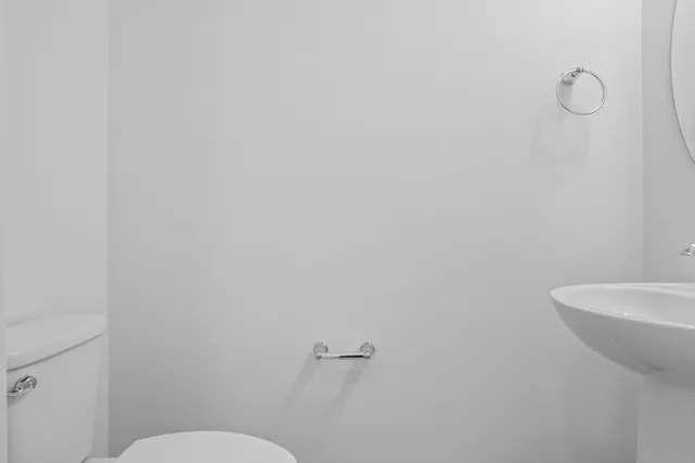 a white toilet sitting next to a white sink