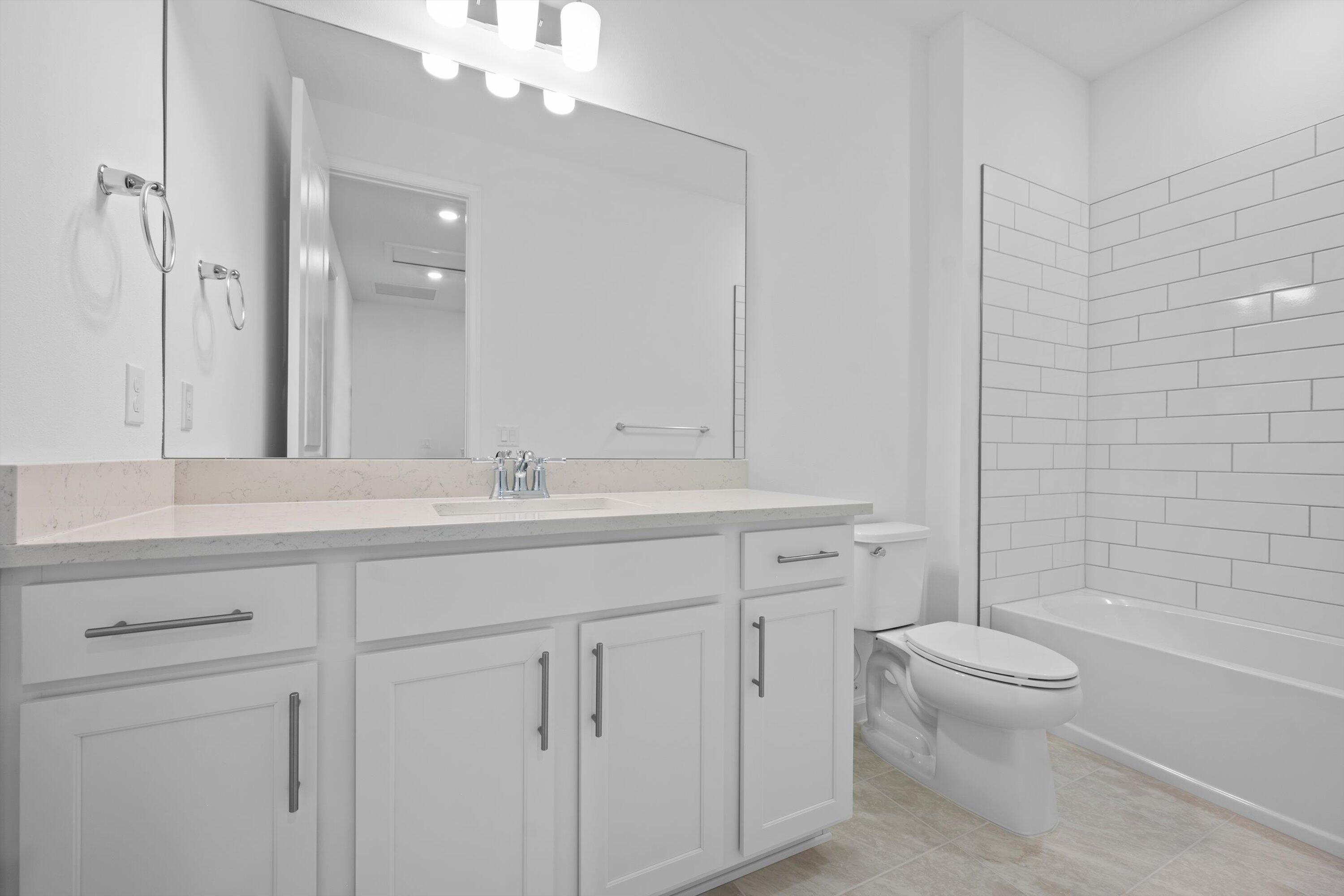 7638 Southwest Lucy Lane Stuart, FL 34997 - Photo 29 of 45 a bathroom with a toilet a sink and a bathtub