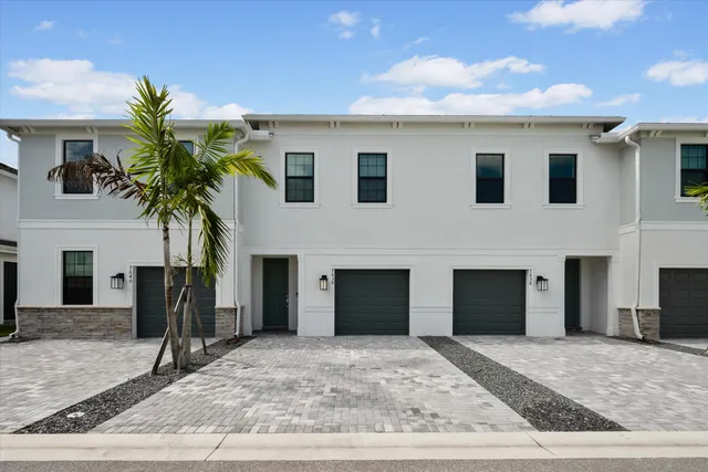 a view of a house with a yard and garage