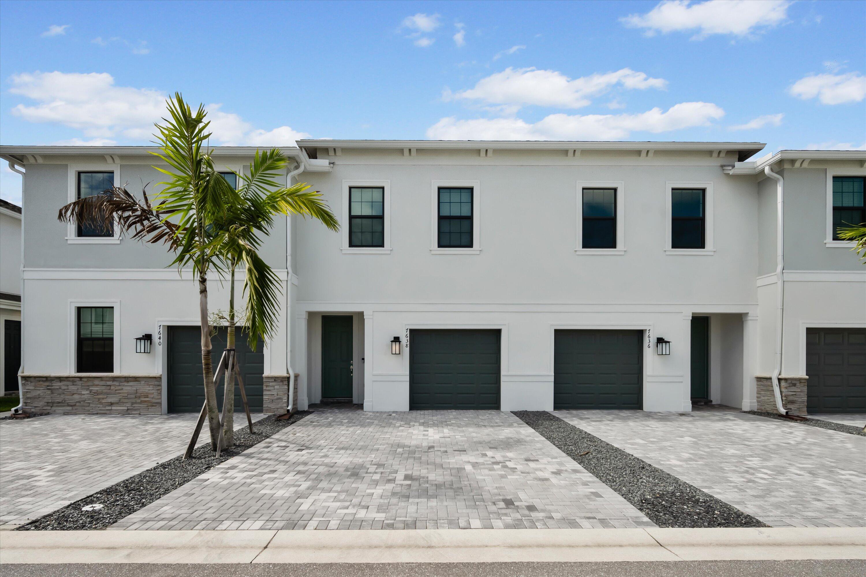 7638 Southwest Lucy Lane Stuart, FL 34997 - Photo 3 of 45 a view of a house with a yard and garage