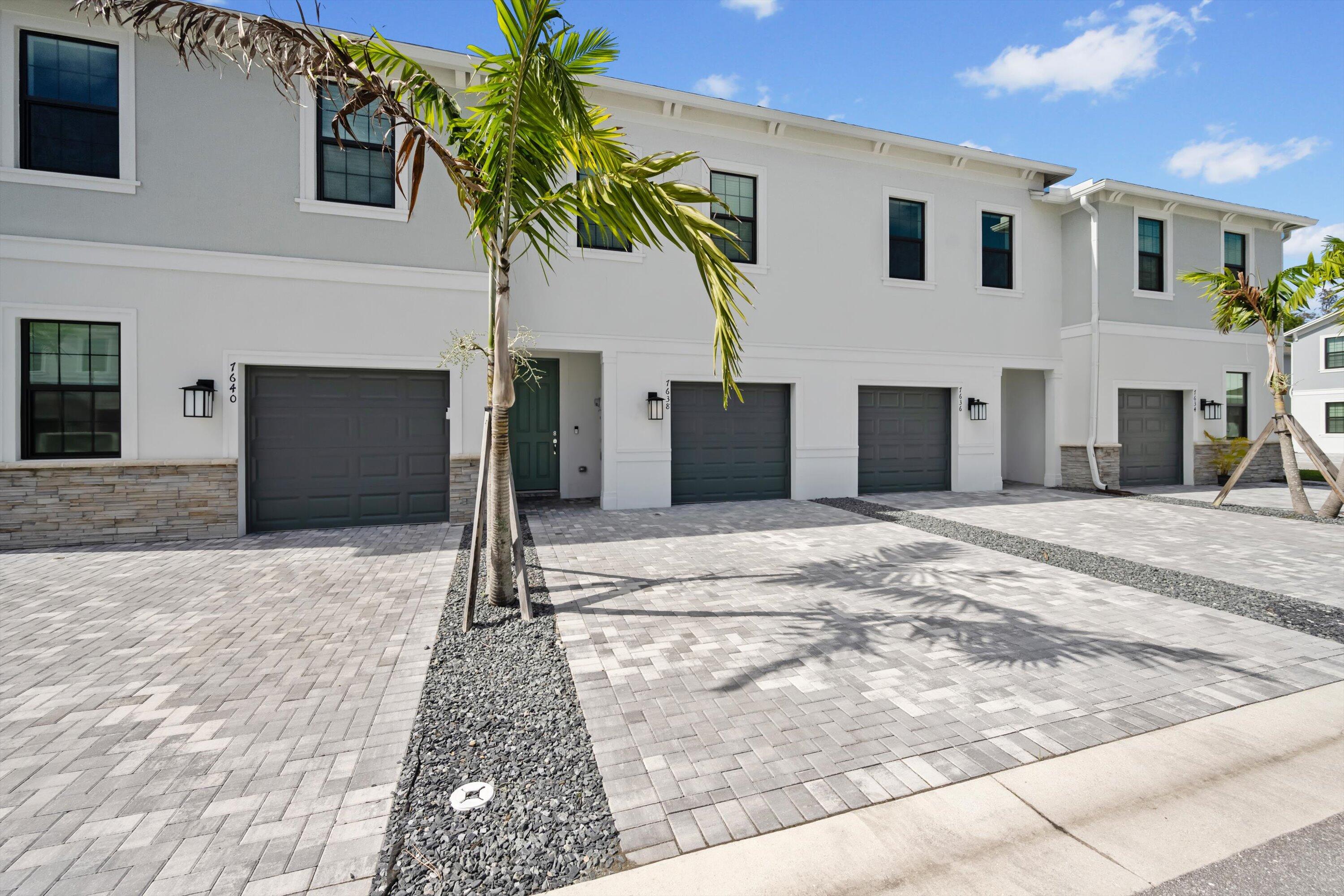 7638 Southwest Lucy Lane Stuart, FL 34997 - Photo 4 of 45 a front view of a house with a yard and garage