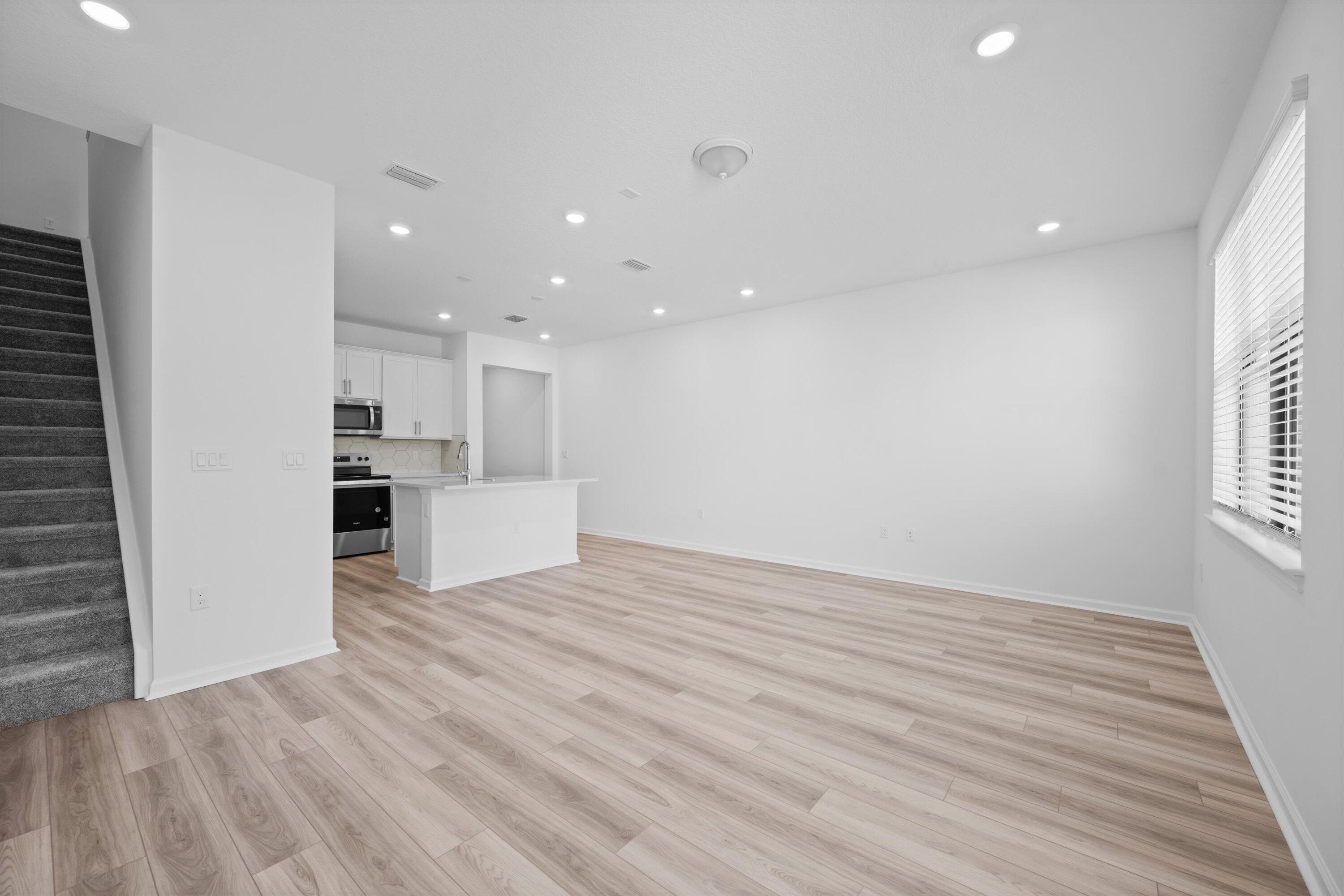 7638 Southwest Lucy Lane Stuart, FL 34997 - Photo 9 of 45 a view of a kitchen with wooden floor and a window