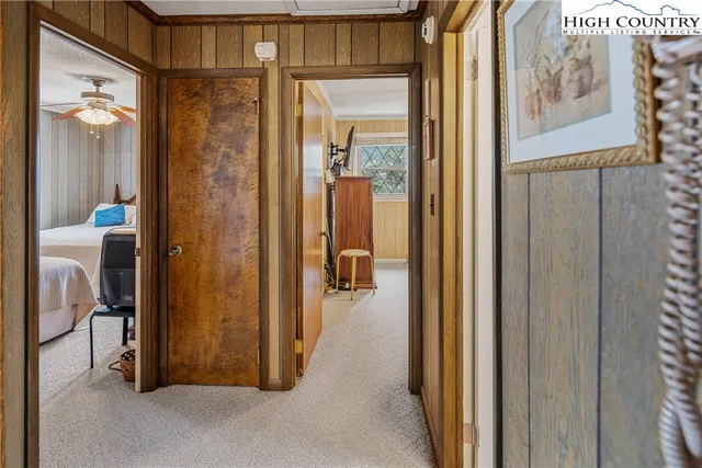 a bedroom with two beds and a chandelier