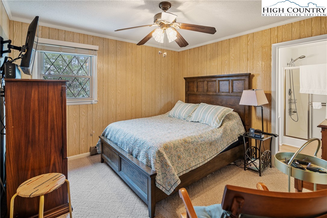 329 Maplewood Circle Boone, NC 28607 - Photo 13 of 46 a bedroom with a bed and a chandelier