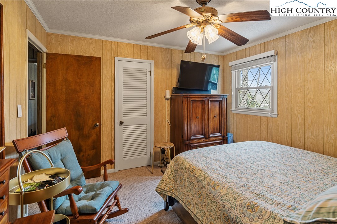 329 Maplewood Circle Boone, NC 28607 - Photo 15 of 46 a bedroom with a bed and a chandelier