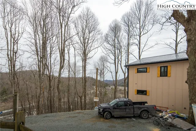 a view of a lush green hillside and houses