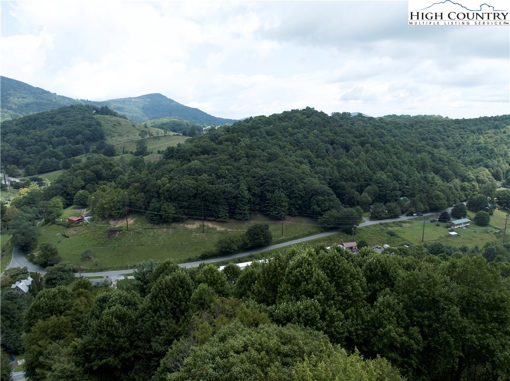 329 Maplewood Circle Boone, NC 28607 - Photo 39 of 46 aerial view of green landscape with trees houses and mountain view