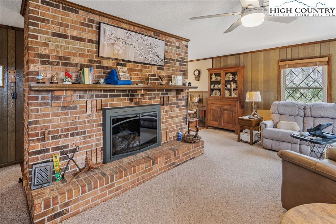 329 Maplewood Circle Boone, NC 28607 - Photo 5 of 46 a living room with furniture a fireplace and a flat screen tv