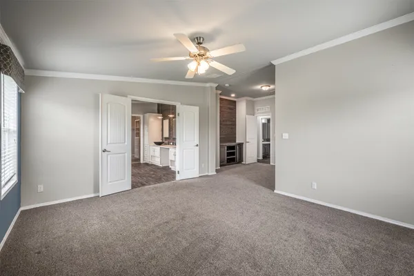 a view of a livingroom with a ceiling fan and window