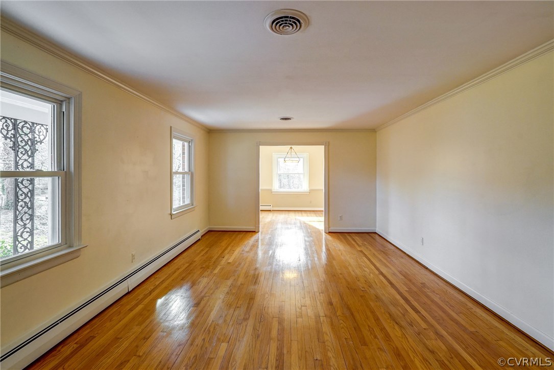 4208 Croatan Road Richmond, VA 23235 - Photo 13 of 50 a view of an empty room with wooden floor and a window