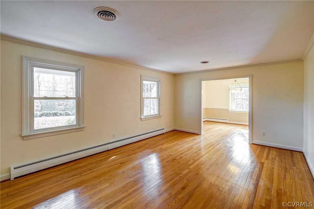 4208 Croatan Road Richmond, VA 23235 - Photo 14 of 50 a view of an empty room with wooden floor and a window