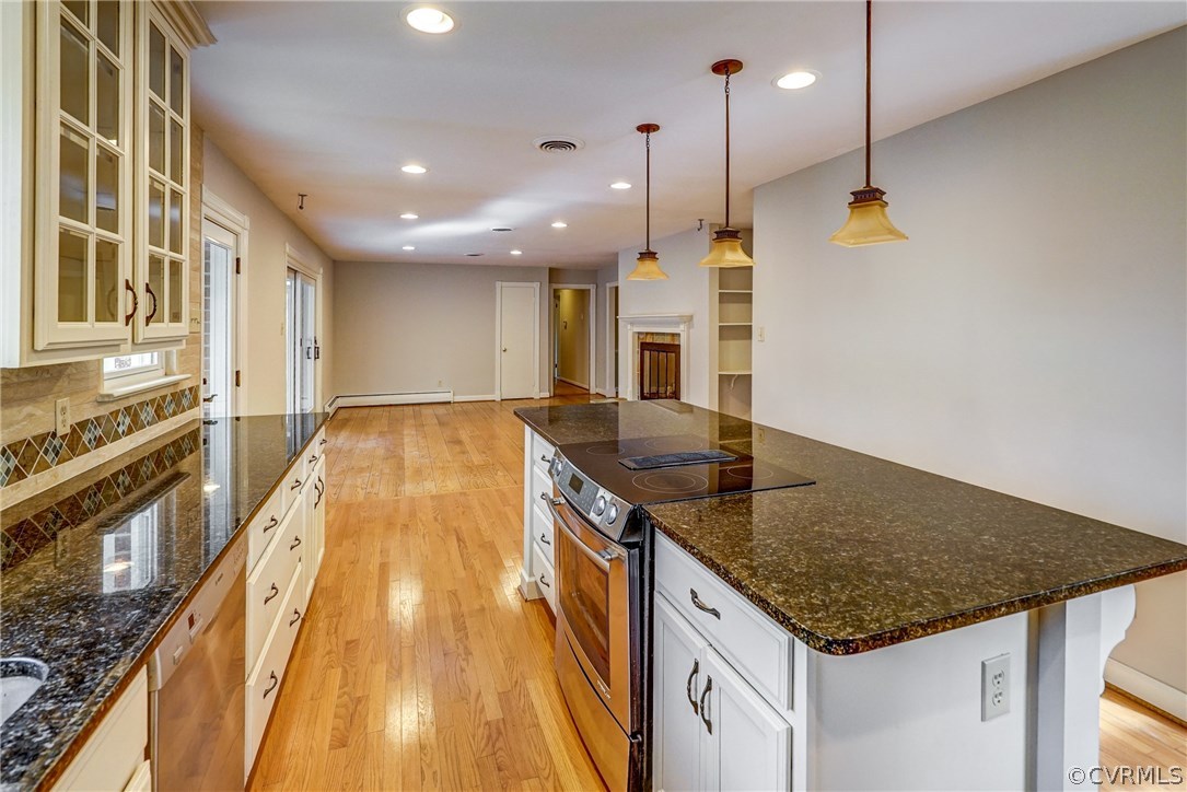 4208 Croatan Road Richmond, VA 23235 - Photo 22 of 50 a kitchen with kitchen island a sink stove and wooden floor