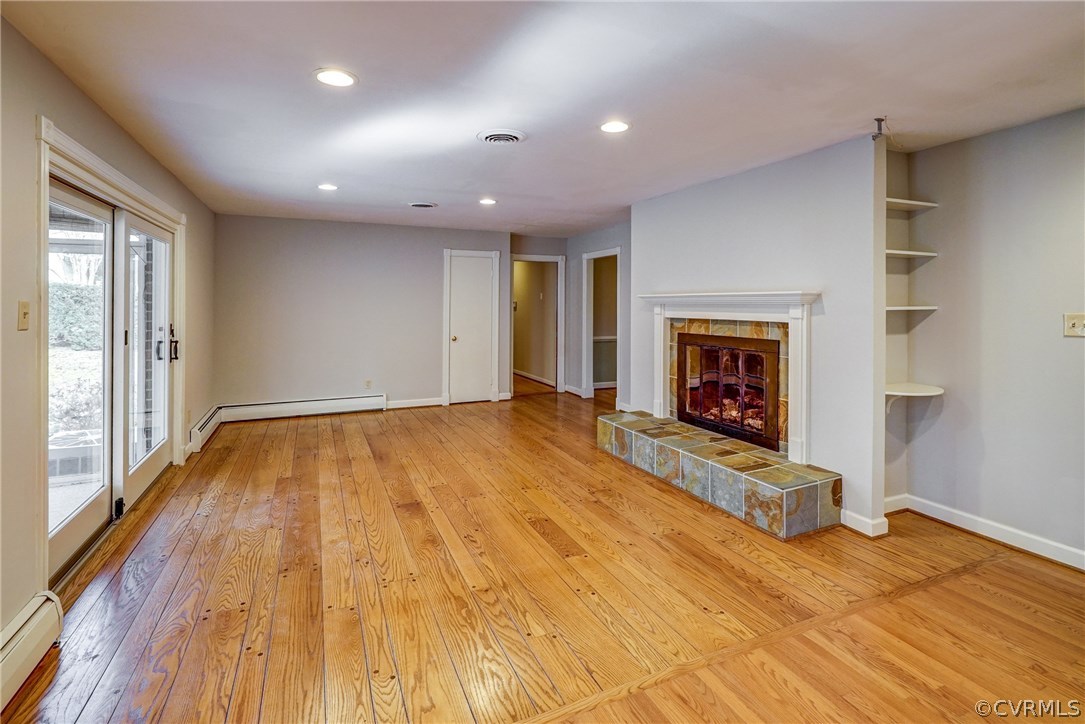 4208 Croatan Road Richmond, VA 23235 - Photo 23 of 50 a view of empty room with wooden floor and fireplace