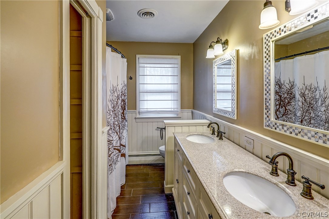 4208 Croatan Road Richmond, VA 23235 - Photo 30 of 50 a bathroom with a granite countertop sink and a mirror