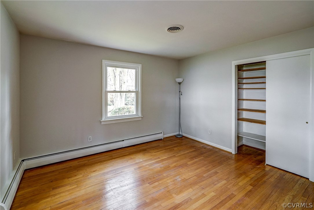 4208 Croatan Road Richmond, VA 23235 - Photo 34 of 50 an empty room with wooden floor closet and windows