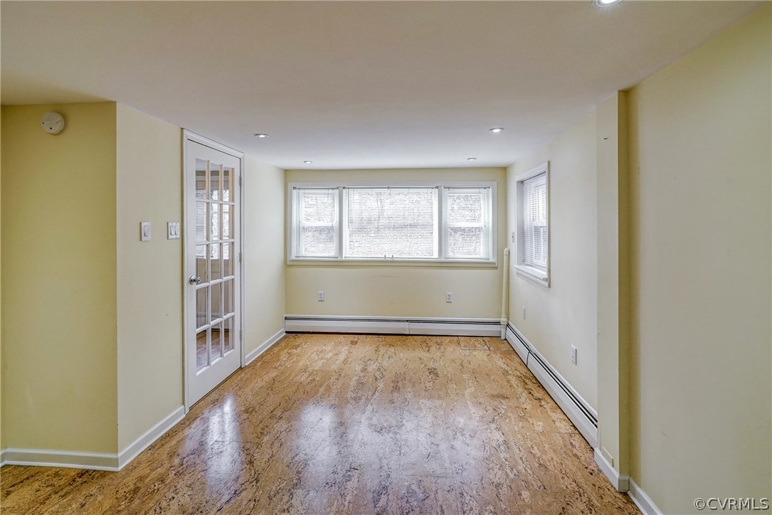 4208 Croatan Road Richmond, VA 23235 - Photo 39 of 50 a view of an empty room with a window and wooden floor